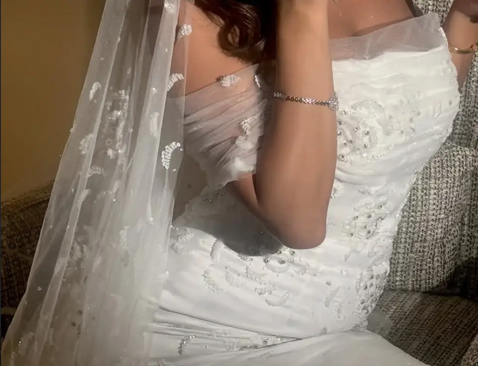 Draped tulle bodice with hand-beaded motifs and a beaded veil